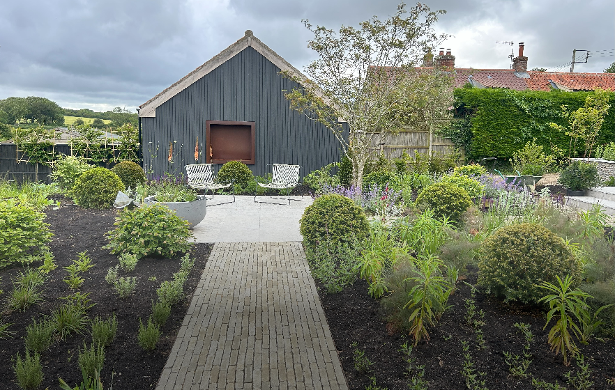 A landscaping example of a beautiful outdoor space with lots of plants.